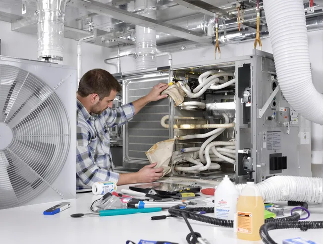 Foxborough Air Duct Cleaning specialist performing precision AC coil cleaning in Foxborough