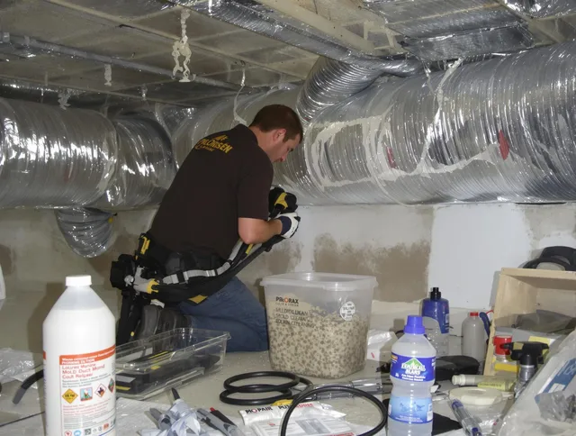 Foxborough Air Duct Cleaning specialist performing professional mold removal from air ducts in Foxborough