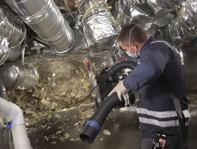 Foxborough Air Duct Cleaning specialist operating negative pressure cleaning equipment for thorough duct maintenance in Foxborough