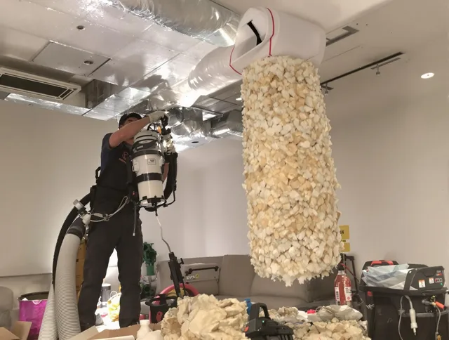 Foxborough Air Duct Cleaning technician performing precision vacuum insulation removal in a residential property in Foxborough